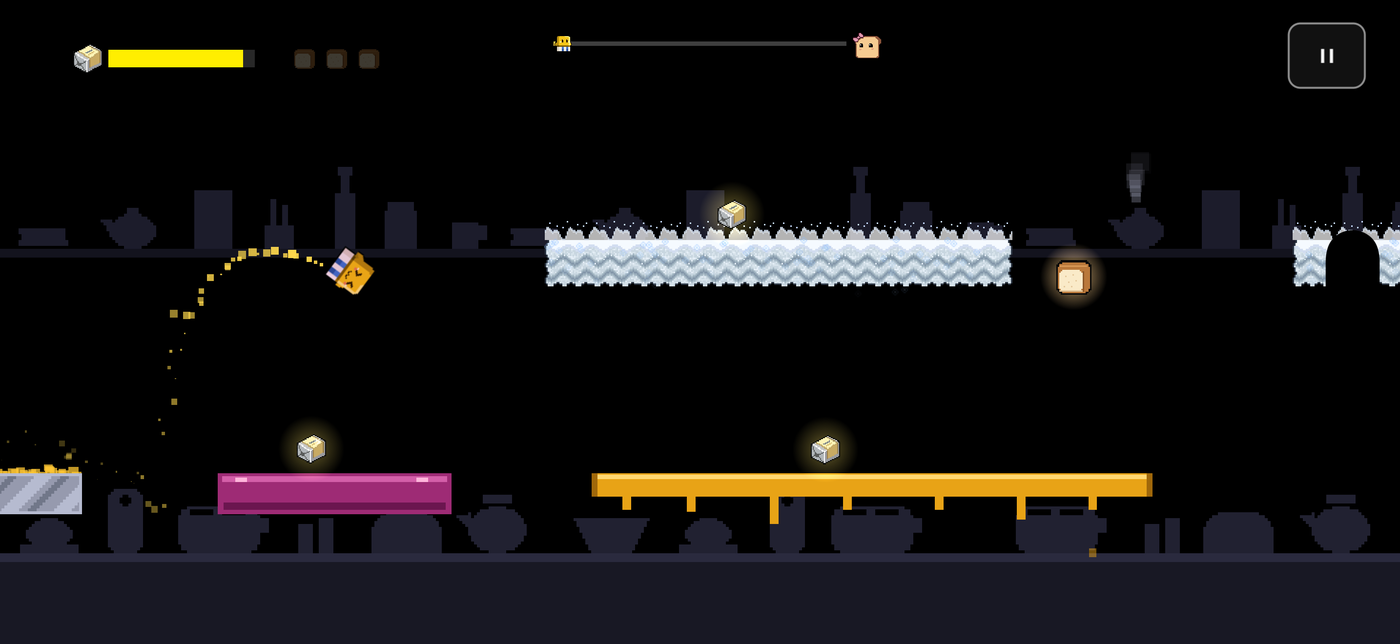 The butter cube mid-jump above a jelly pad and a snow platform